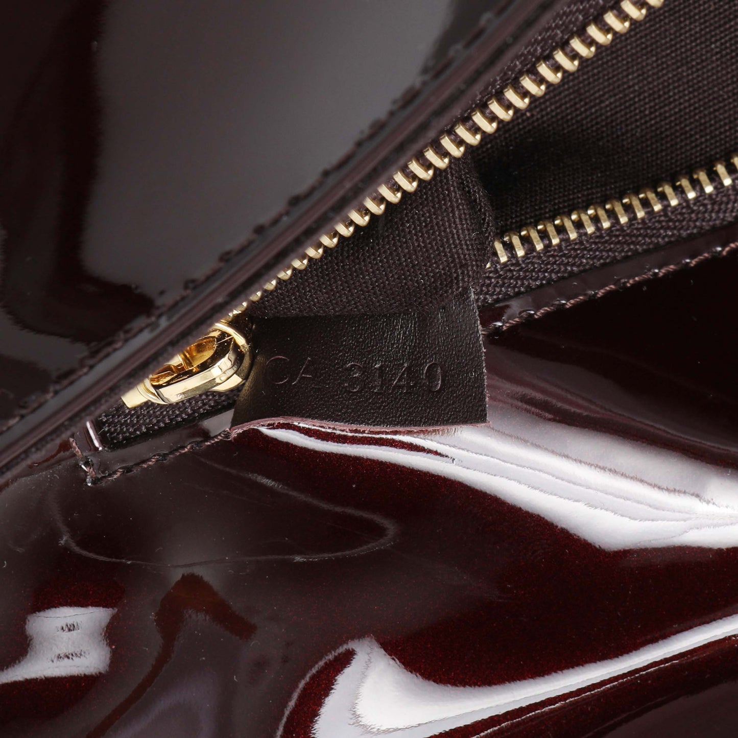 Exclusive Louis Vuitton Amarante Patent Sobe Clutch — Lifestyle View