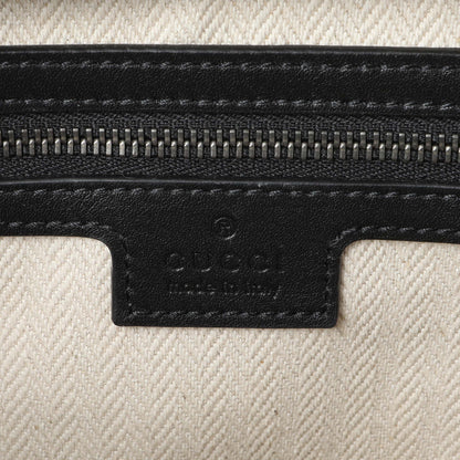 Exclusive Gucci GG Supreme Monogram Calfskin Emblem Small Crossbody — Detail View