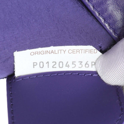 Exclusive Bottega Veneta Purple Paper Calfskin Maxi Intreccio Extra Mini Cassette Crossbody Bag — Lifestyle View