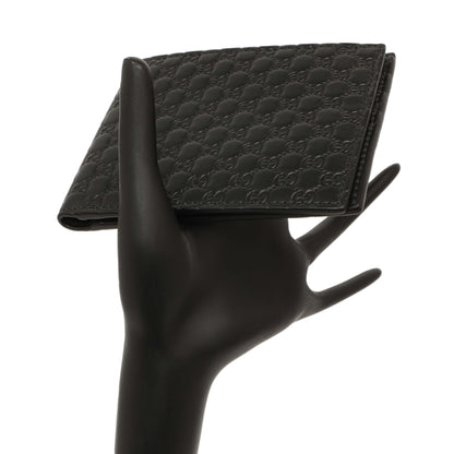Exclusive Gucci Black Microguccissima Bi-Fold Wallet — Lifestyle View